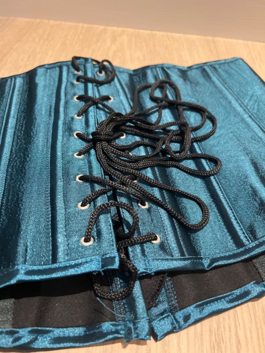 Taljecorset i gr&oslash;n med h&aelig;gter foran og sn&oslash;rer p&aring; ryg. Talje: 80-100cm